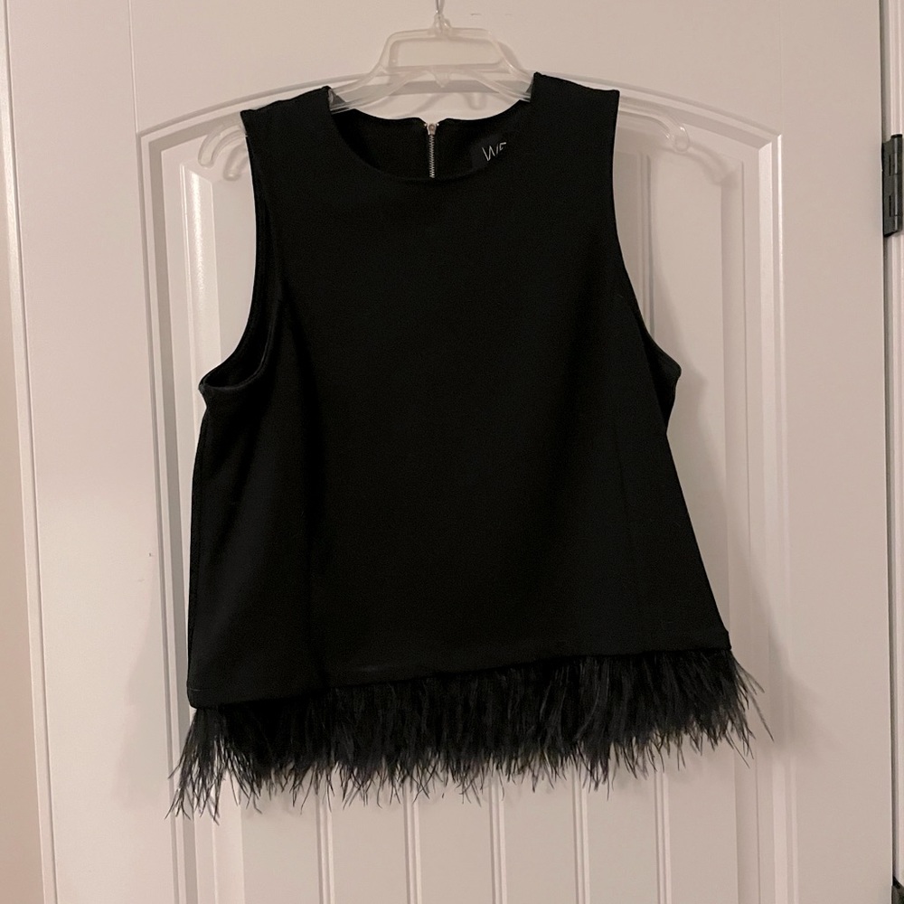 Sleeveless black top with feather bottom trim